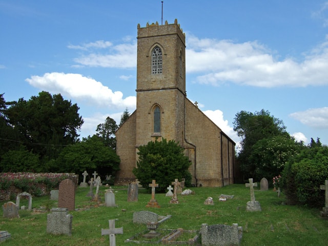 Stone church with graveyard surrounded by trees — ecclesiastical restoration