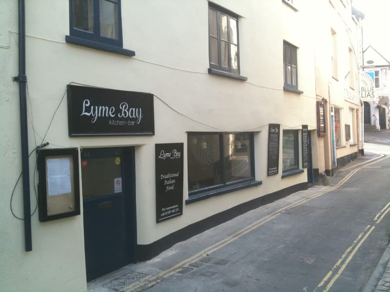 Lime-washed render on commercial building exterior, Lyme Bay
