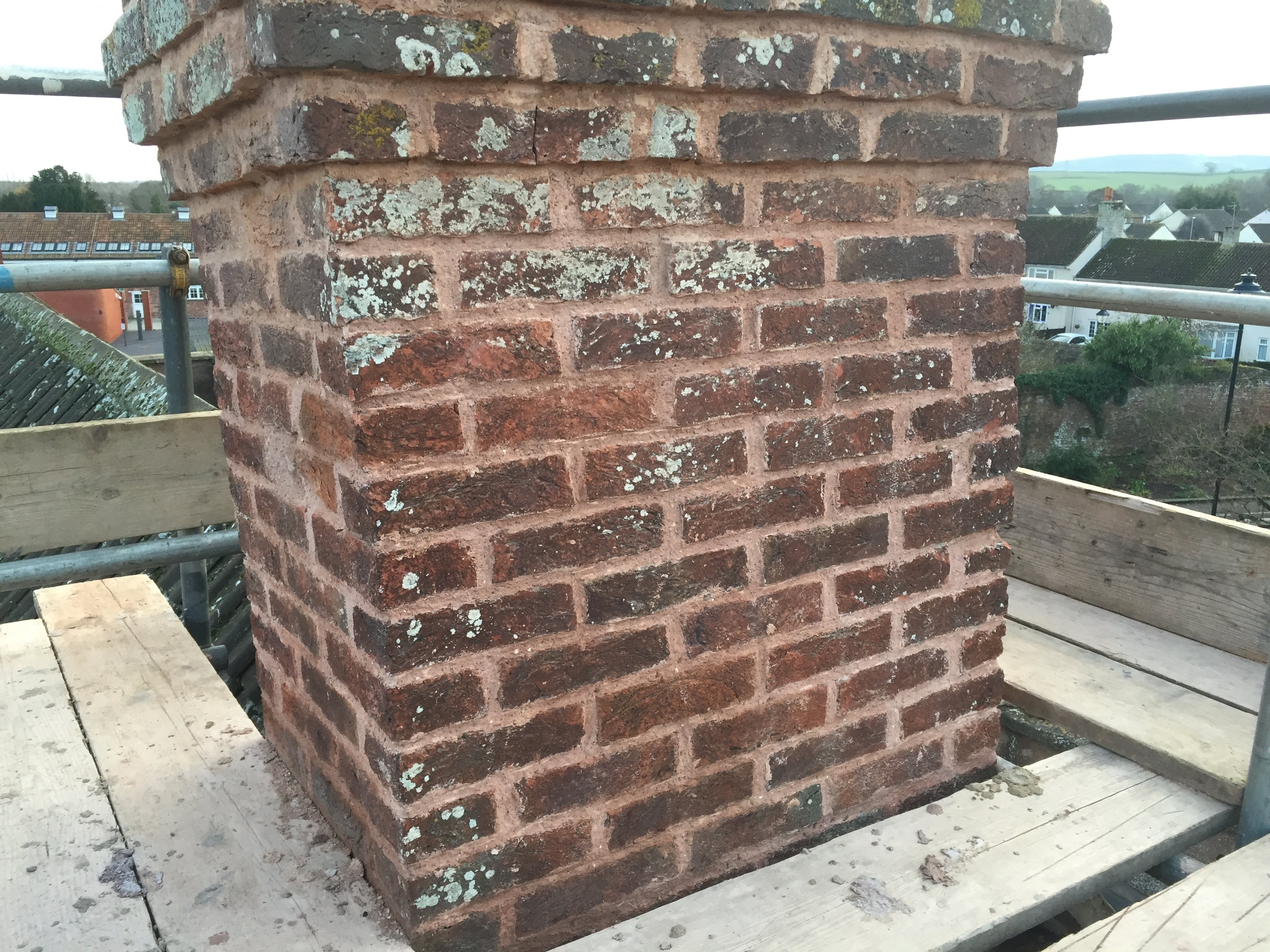 Brick chimney stack repointing on scaffolding